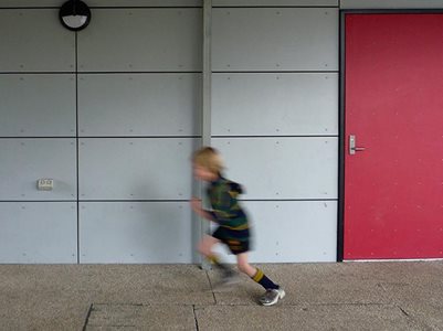 Child running past plaspanel exterior cladding