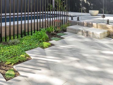 A monochromatic palette was chosen for the architectural materials in the garden and poolscape design