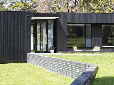 The new residence is a low profile, charred timber and glass façade creation