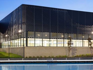 Long-length perforated panels were used to achieve building coverage as well as deliver maximum privacy and light for users
