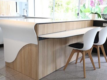 The curved edge quasi waterfall style gives an elegant touch to the kitchen bench 