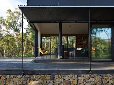The off grid house featuring low-carbon fibre cement board cladding and decking, and a 2.4-metre external metal screen 