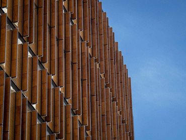 The timber and glass facade on EY Centre featuring Prodema PRODEX Natural Timber louvres