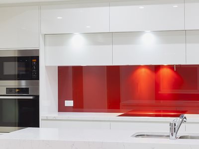 Modern kitchen interior with red splashback