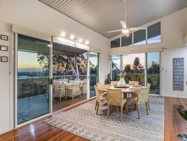This two-level family home features wraparound balconies, all accessed through large sliding doors protected with Invisi-Gard screens