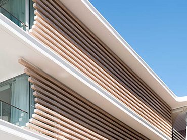 Ever Art Wood horizontal timber look battens cut and staggered at different lengths to create the crescent shaped feature screens