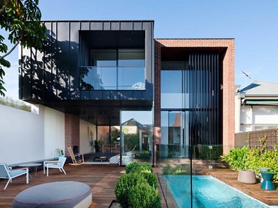 residential back yard swimming pool red brick black aluminium