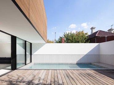 The external facade benefits from the warmth and texture of the linear timber slats