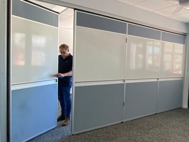 The operable wall features a full height pass door