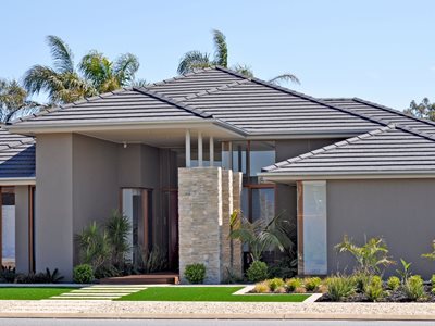Exterior view of modern residential home with grey concrete roof tiles 