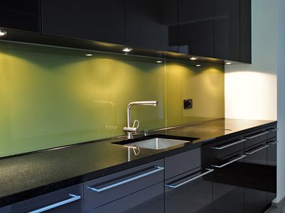 Modern kitchen interior with green splashback