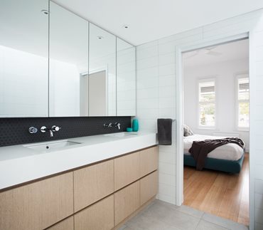 A bathroom and bedroom make up the majority of the first floor and lead to an additional living area which overlooks the void at the back of the house