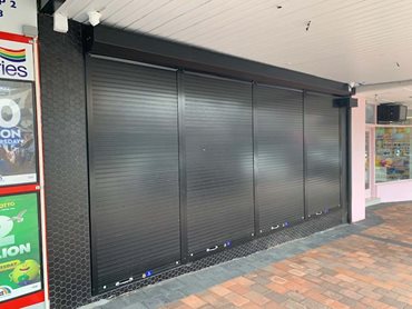 These security shutters fold out of the way completely - Great White Tattoo in Kirrawee