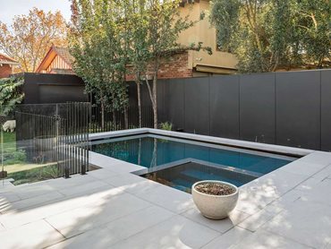 A stunning pool featuring a chunky edge is the highlight of the courtyard 
