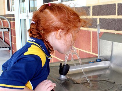 Galvin Engineering School Child Drinking From Water Fountain School Playground