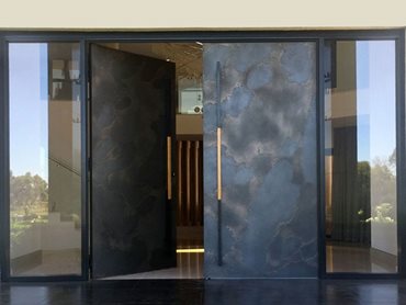 Axolotl glass doors transcend traditional boundaries by incorporating various materials to create a unique statement