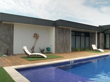 The Plenty home, featuring LuxeWall panels on the exterior, is designed around a fully tiled concrete pool/spa