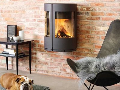 Castworks Morso Cast Iron Danish Wood Fire Heater Installed onto Brick Wall in Living Room