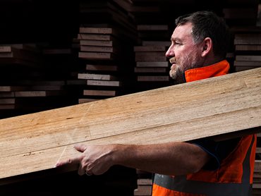 Tradesman Carrying Wood on Shoulder