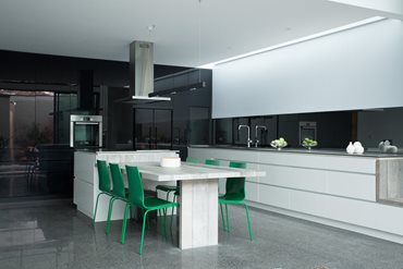 A kitchen and living space sits at the back of the house 