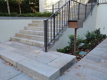 Antique Salmon Granite and Antique Pewter Granite were used for the stair treads and paving at the home’s entrance 