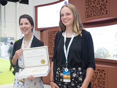 Melbourne Girls&rsquo; College students Gina Handby (Left) and Caitlin O&rsquo;Shea (Right) display the school&rsquo;s 2015 Zayed Future Energy Prize in front of Masdar&rsquo;s Abu Dhabi Sustainability Week stand in January 2015. Image: http://zayedsustainabilityprize.com&nbsp;
