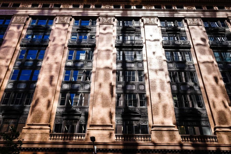 New Ideas for Old Buildings aims to develop ways to make it easier to use Sydney buildings for artistic exhibitions.&nbsp; Image: The Castlereagh Street facade of the Macquarie Bank building is dappled in reflected light (702 ABC Sydney: John Donegan)
