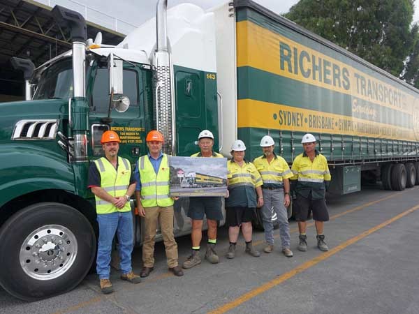 Hyne Timber Tuan employees and Richers Transport with the presentation photo (Image: Hyne Timber)