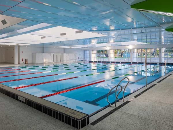 The seamless high gloss surface of the CRYSTAL taut membrane reflects the blue of the pools below
