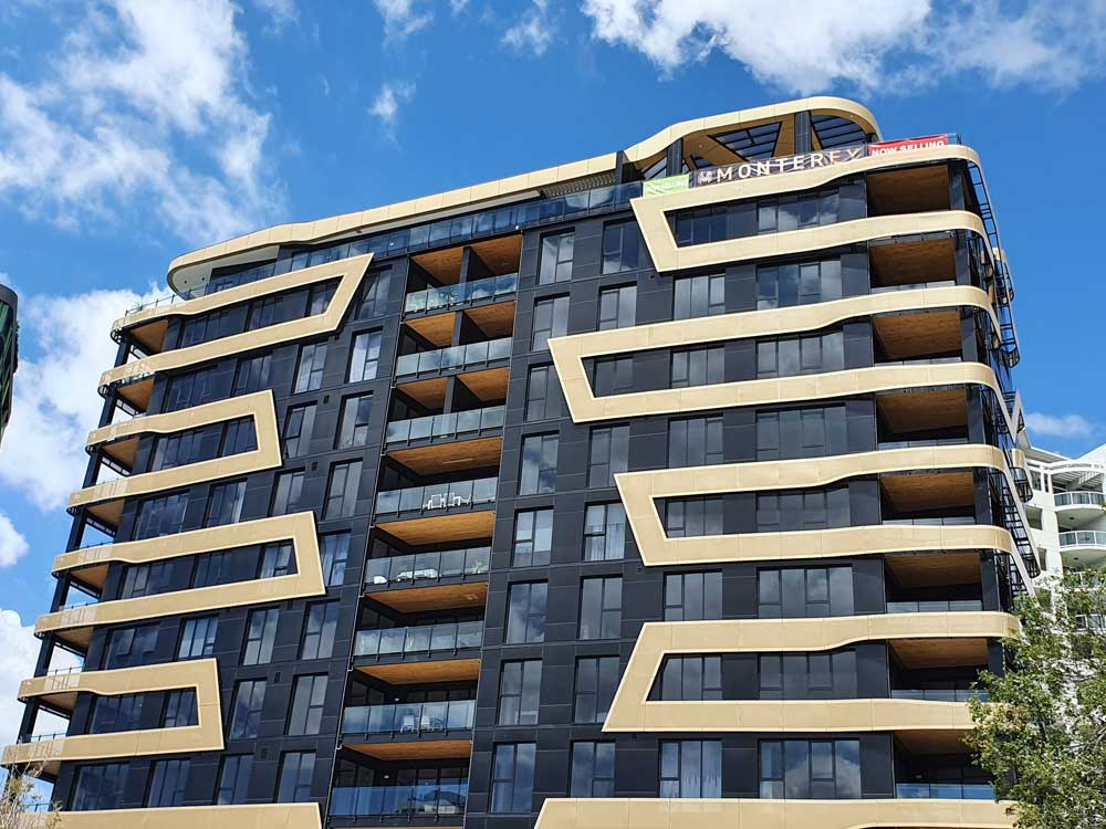 Monterey Apartments featuring black and gold Aodeli SAP cladding